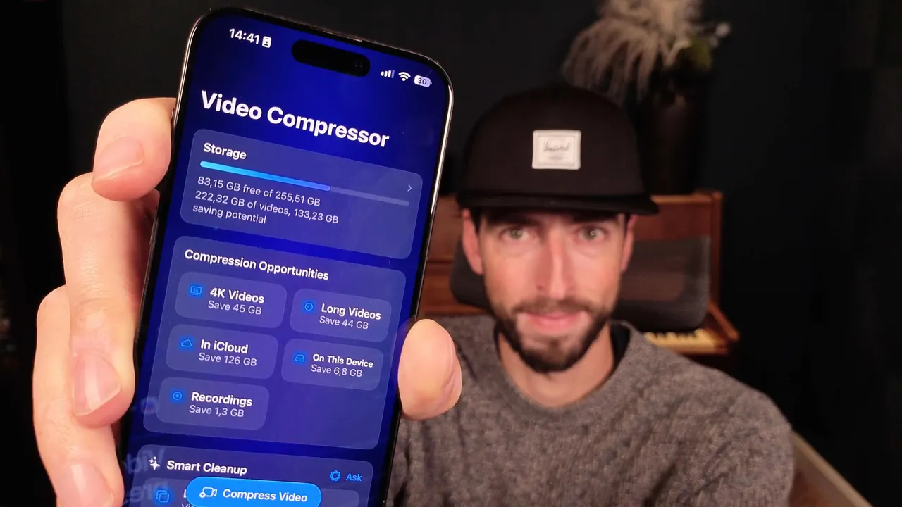 Antoine van der Lee holding an iPhone that shows the Video Compressor home screen with storage and compression opportunities.